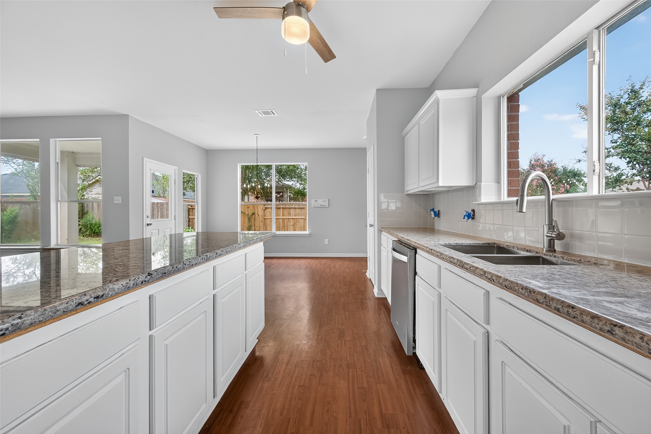 1302 Cross Draw Drive Houston, TX 77067 - Photo 13 of 35 a large kitchen with granite countertop a large counter top space a sink a window and stainless steel appliances