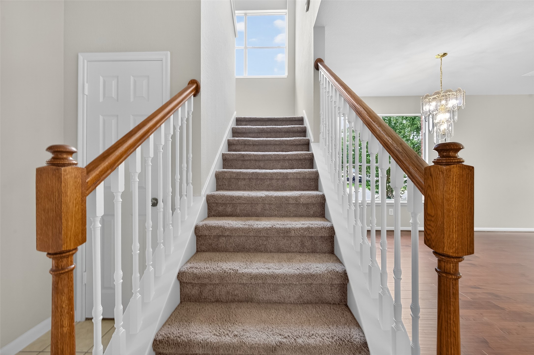 1302 Cross Draw Drive Houston, TX 77067 - Photo 14 of 35 a view of staircase with lots of frames on wall and a chandelier