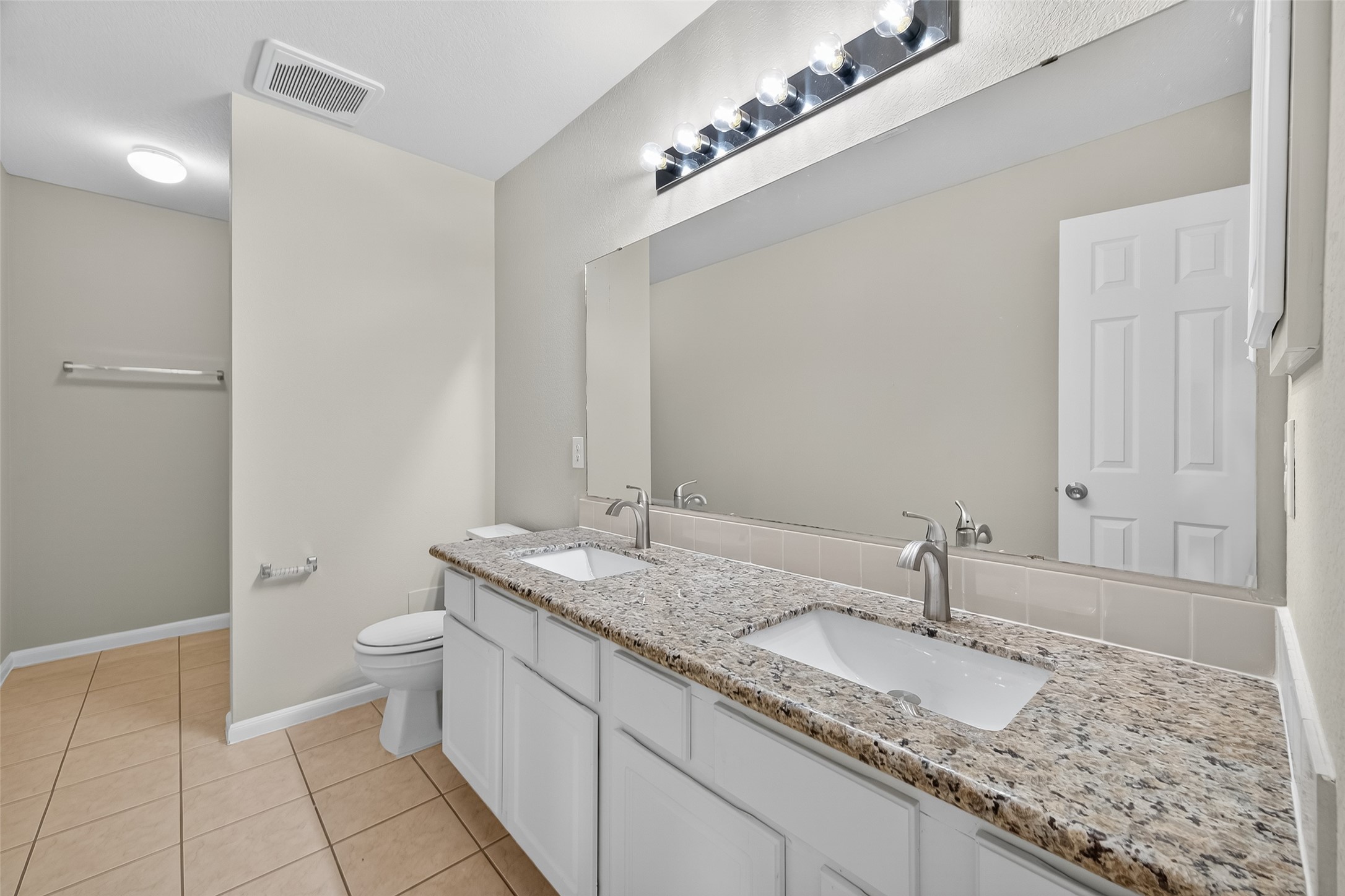 1302 Cross Draw Drive Houston, TX 77067 - Photo 31 of 35 a bathroom with a granite countertop double vanity and a mirror