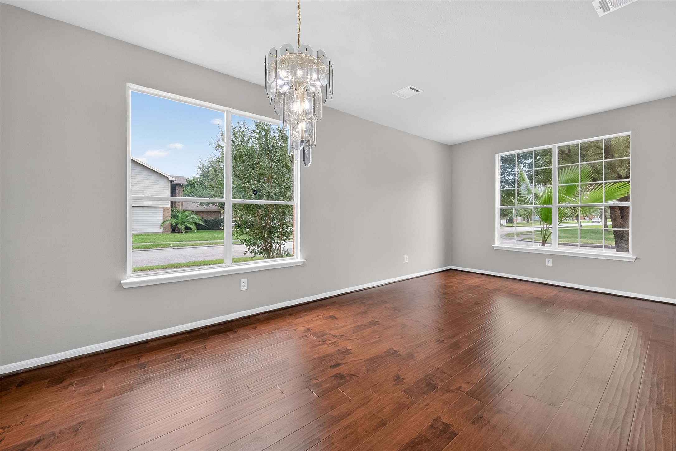 1302 Cross Draw Drive Houston, TX 77067 - Photo 5 of 35 a view of an empty room with wooden floor and a window