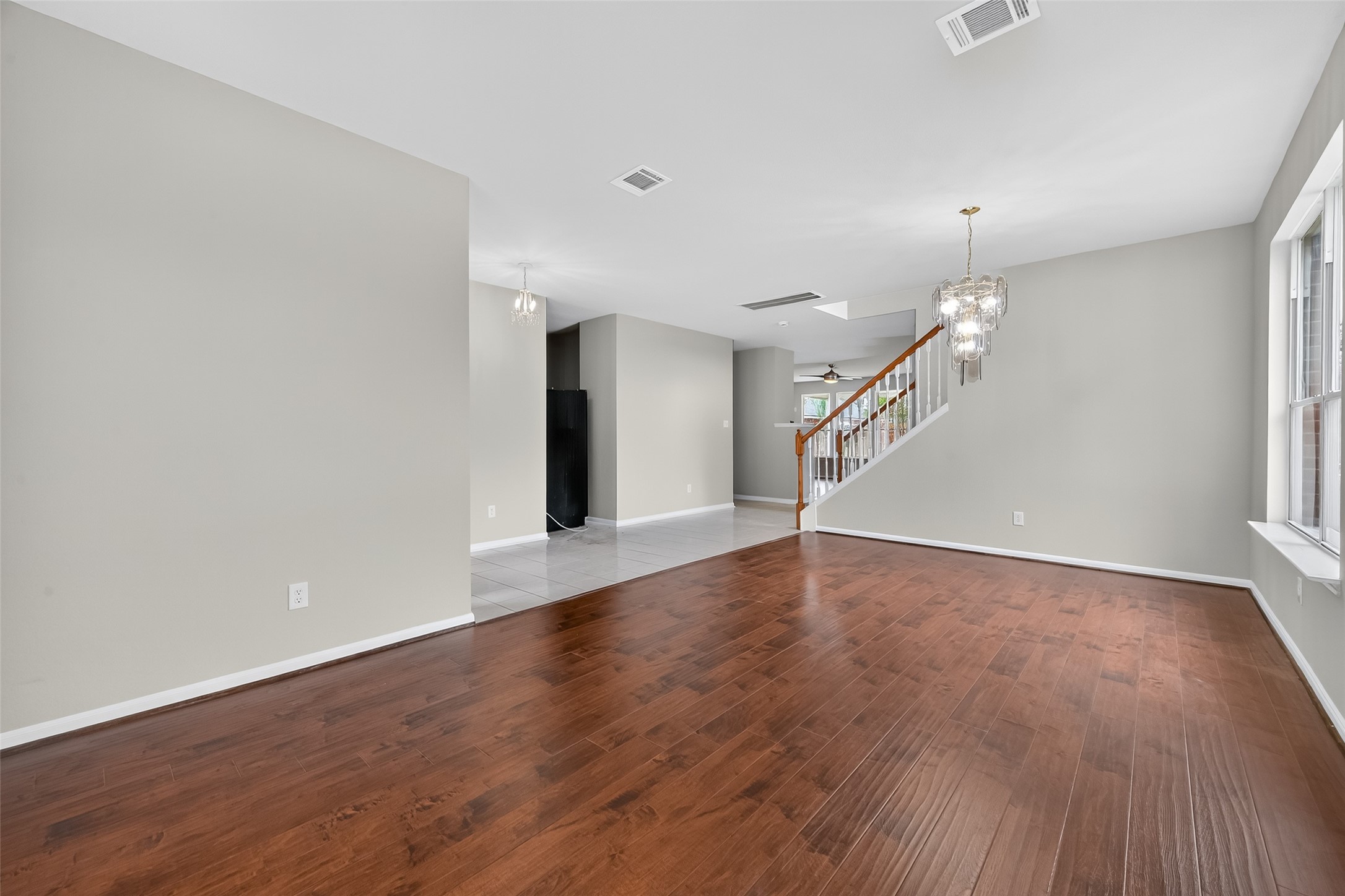 1302 Cross Draw Drive Houston, TX 77067 - Photo 6 of 35 a view of an empty room with wooden floor and stairs