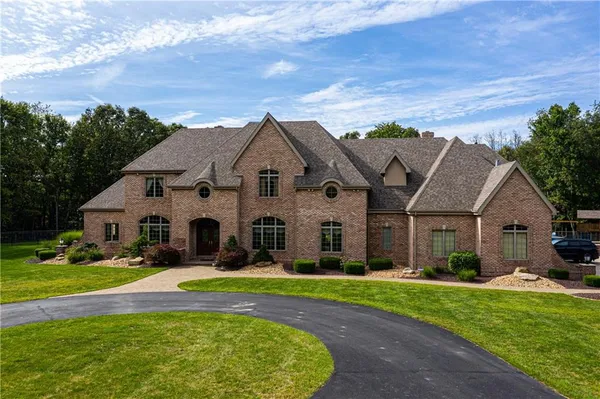a view of house with yard and green space