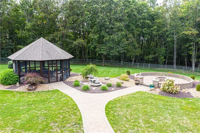 a view of a backyard with table and chairs under an umbrella