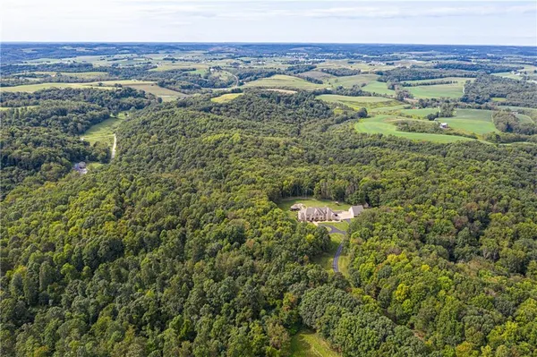 a view of a city with lush green forest