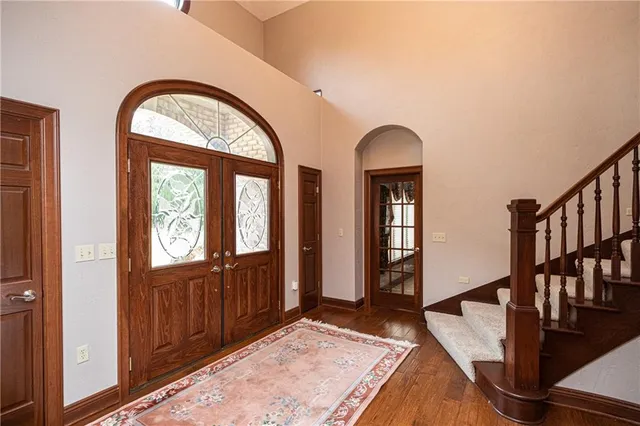 a view of an entryway with wooden floor and windows