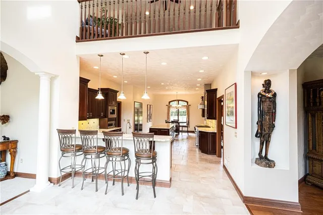 a very nice looking living room with a large window and kitchen view