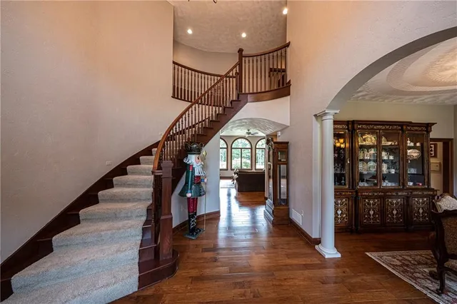 a view of entryway and hall with wooden floor