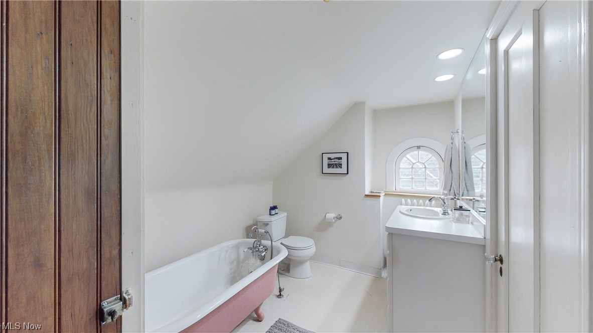 3316 Avalon Road Cleveland, OH 44120 - Photo 28 of 42 Bathroom featuring a tub, vanity, tile floors, toilet, and vaulted ceiling