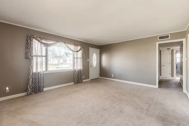 an empty room with windows and closet