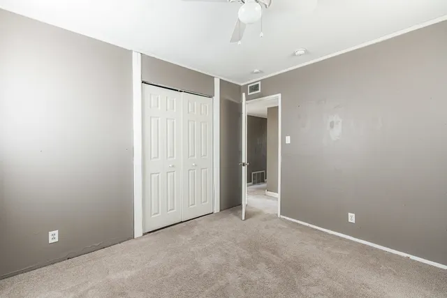 an empty room with a empty space and a ceiling fan