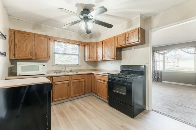 a kitchen with stainless steel appliances granite countertop a stove sink and cabinets