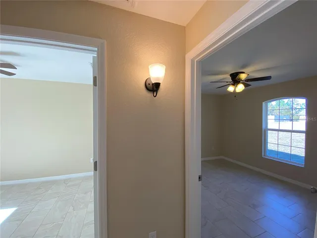 a view of a livingroom with a ceiling fan and window