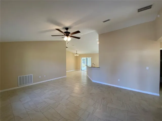 a view of a livingroom with a ceiling fan and chandelier fan