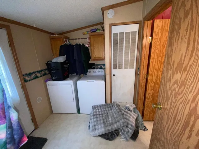 a room with a refrigerator and a window