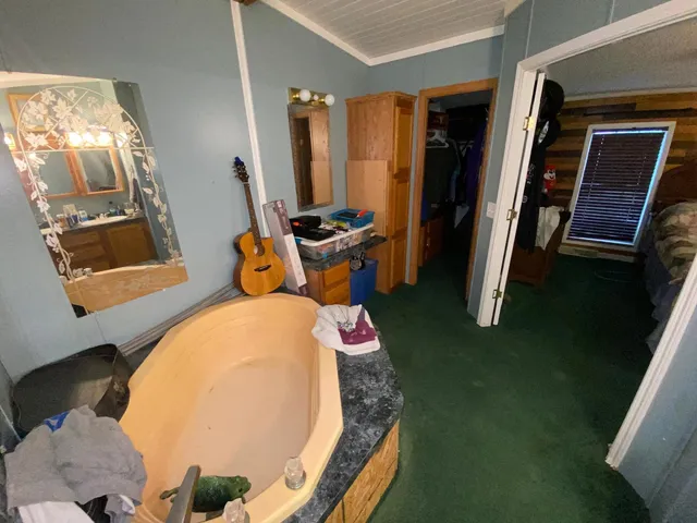 a bed room with a bed and a mirror