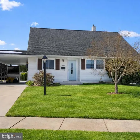 a kitchen with a table chairs a chandelier and kitchen view