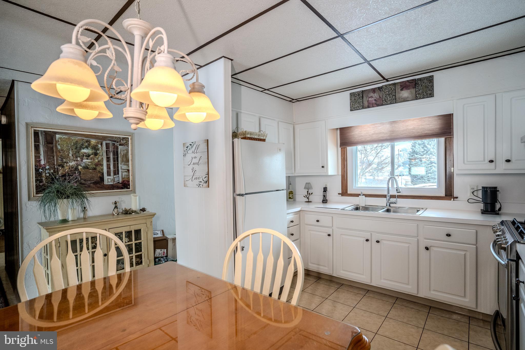 3 Fennimore Road Hamilton, NJ 08690 - Photo 13 of 52 a kitchen with a table chairs a chandelier and kitchen view