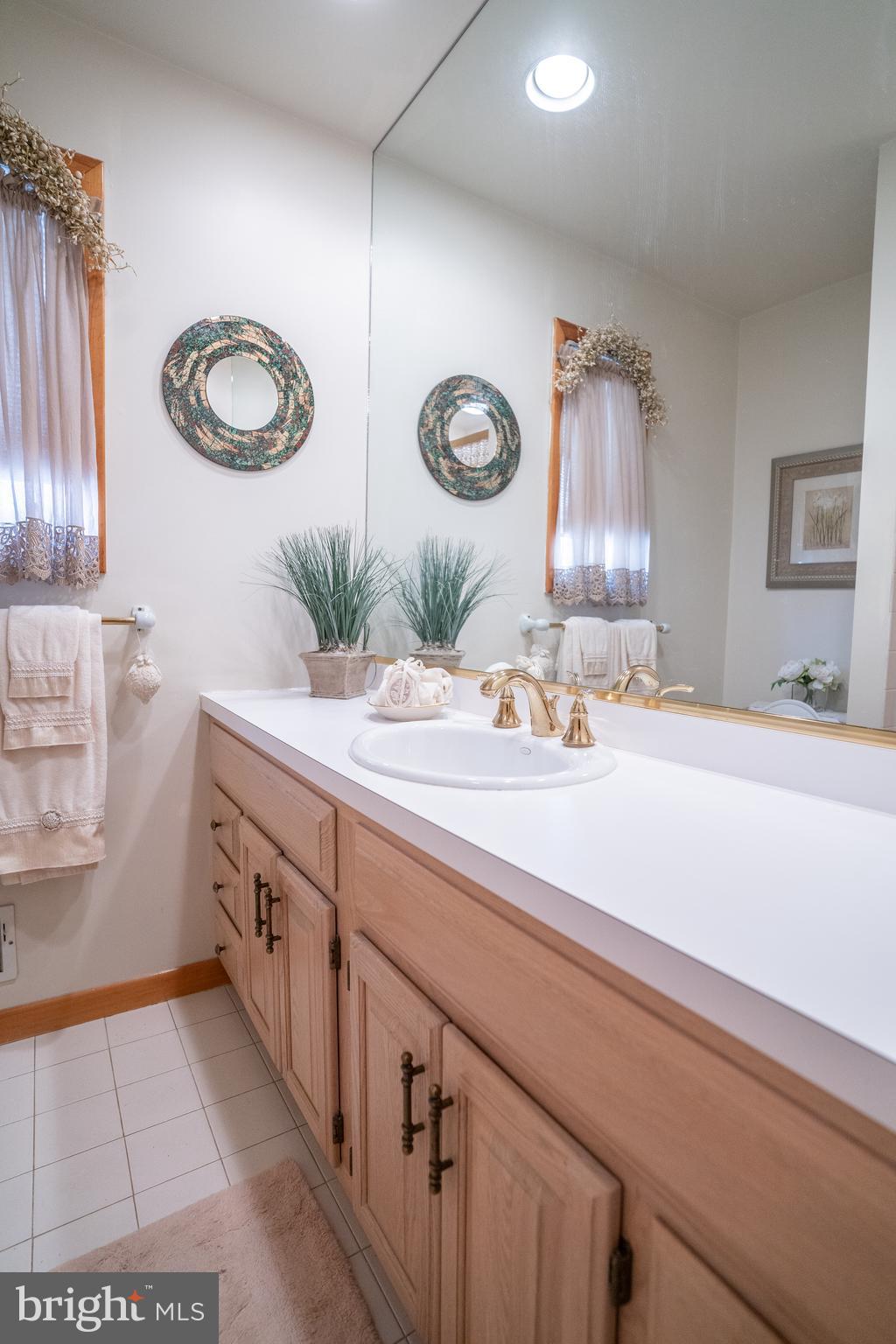 3 Fennimore Road Hamilton, NJ 08690 - Photo 30 of 52 a bathroom with a double vanity sink and a mirror