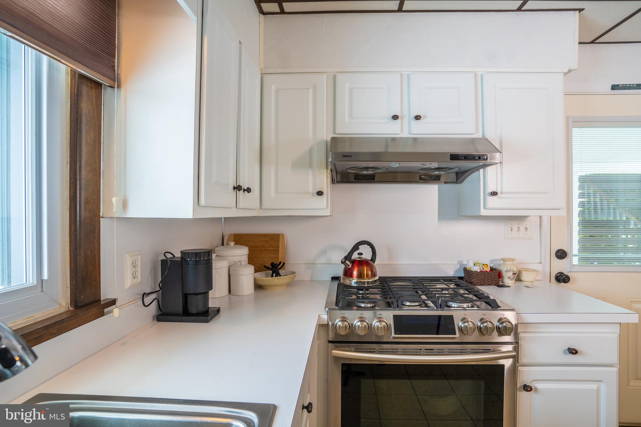 3 Fennimore Road Hamilton, NJ 08690 - Photo 7 of 52 a kitchen with stainless steel appliances a stove and white cabinets