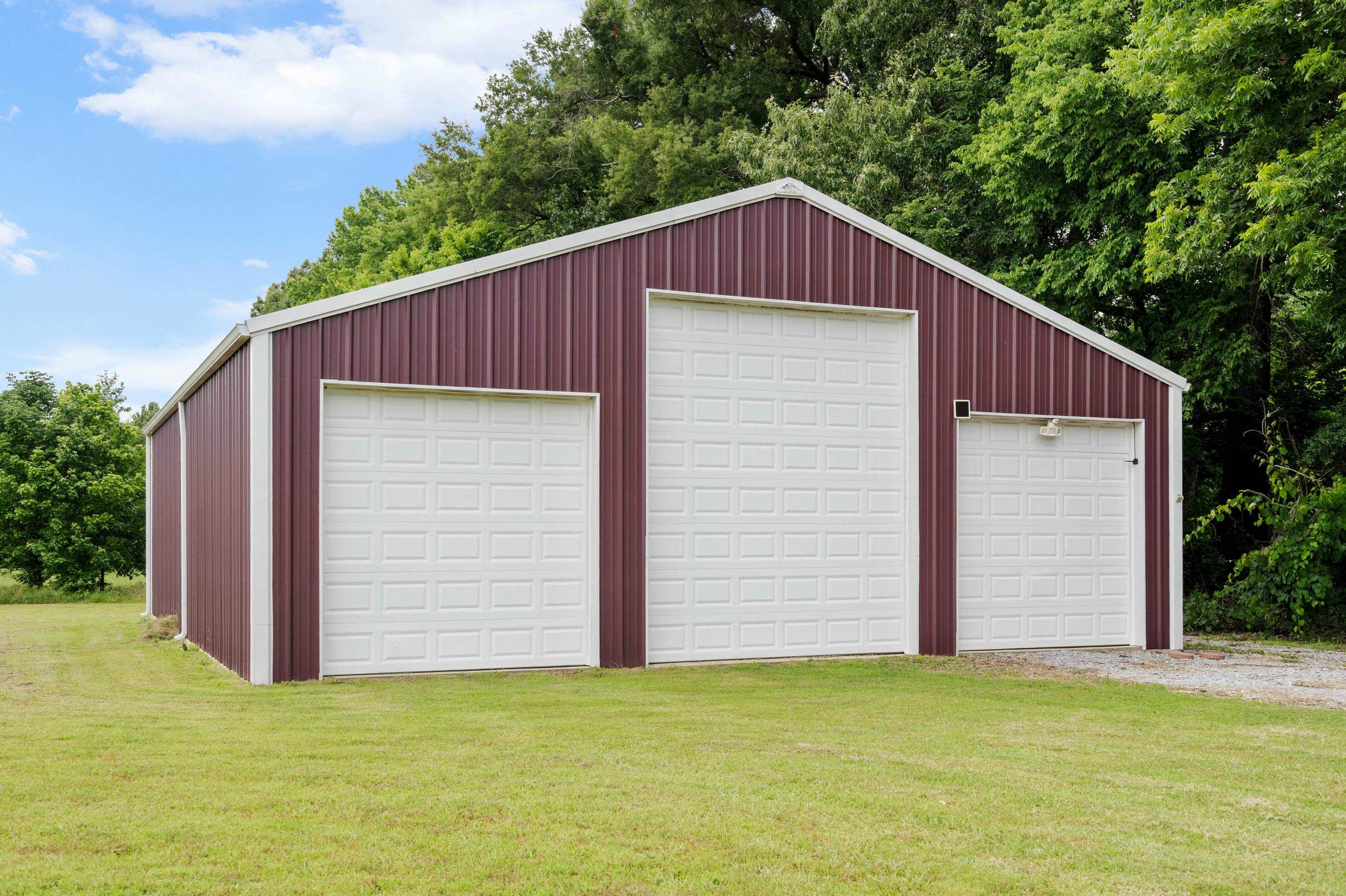 7757 Brunswick Road Millington, TN 38053 - Photo 33 of 40 Metal construction outbuilding featuring three white overhead garage doors