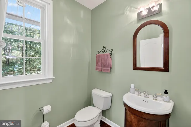 a bathroom with a double vanity sink mirror and bathtub
