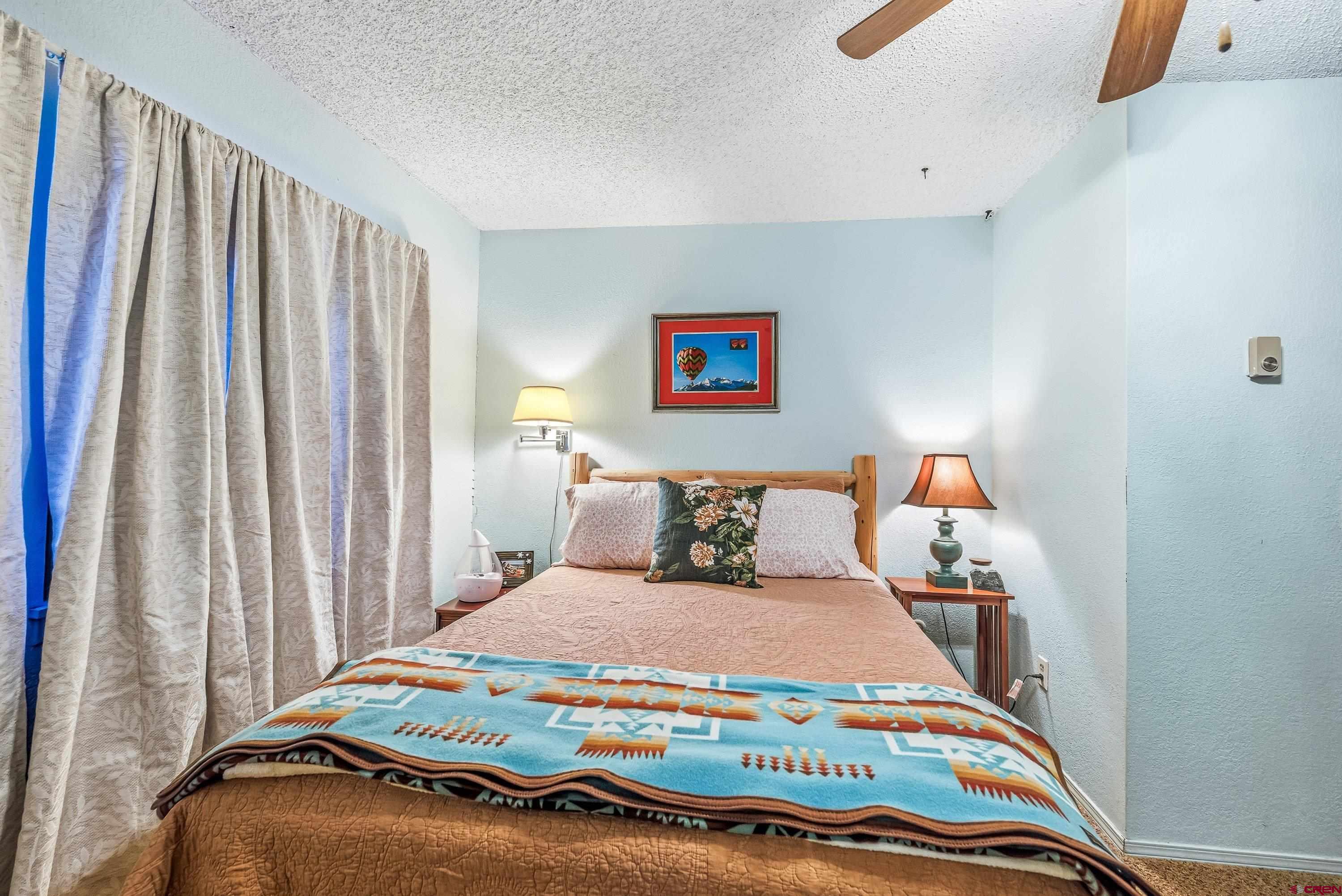 155 East 7th Street Delta, CO 81416 - Photo 11 of 19 a bedroom with bed and a window