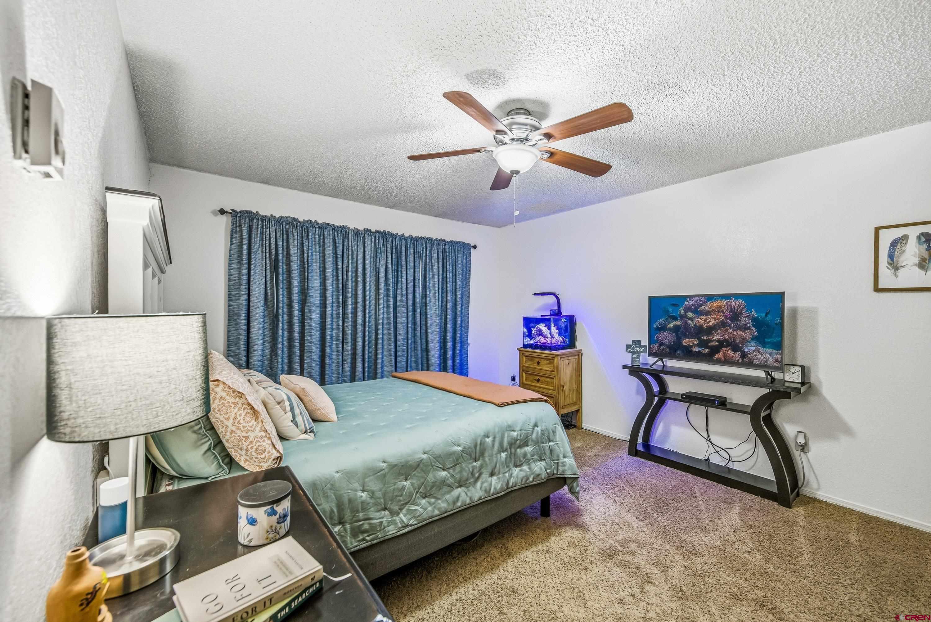 155 East 7th Street Delta, CO 81416 - Photo 13 of 19 a bedroom with a bed workspace and a window