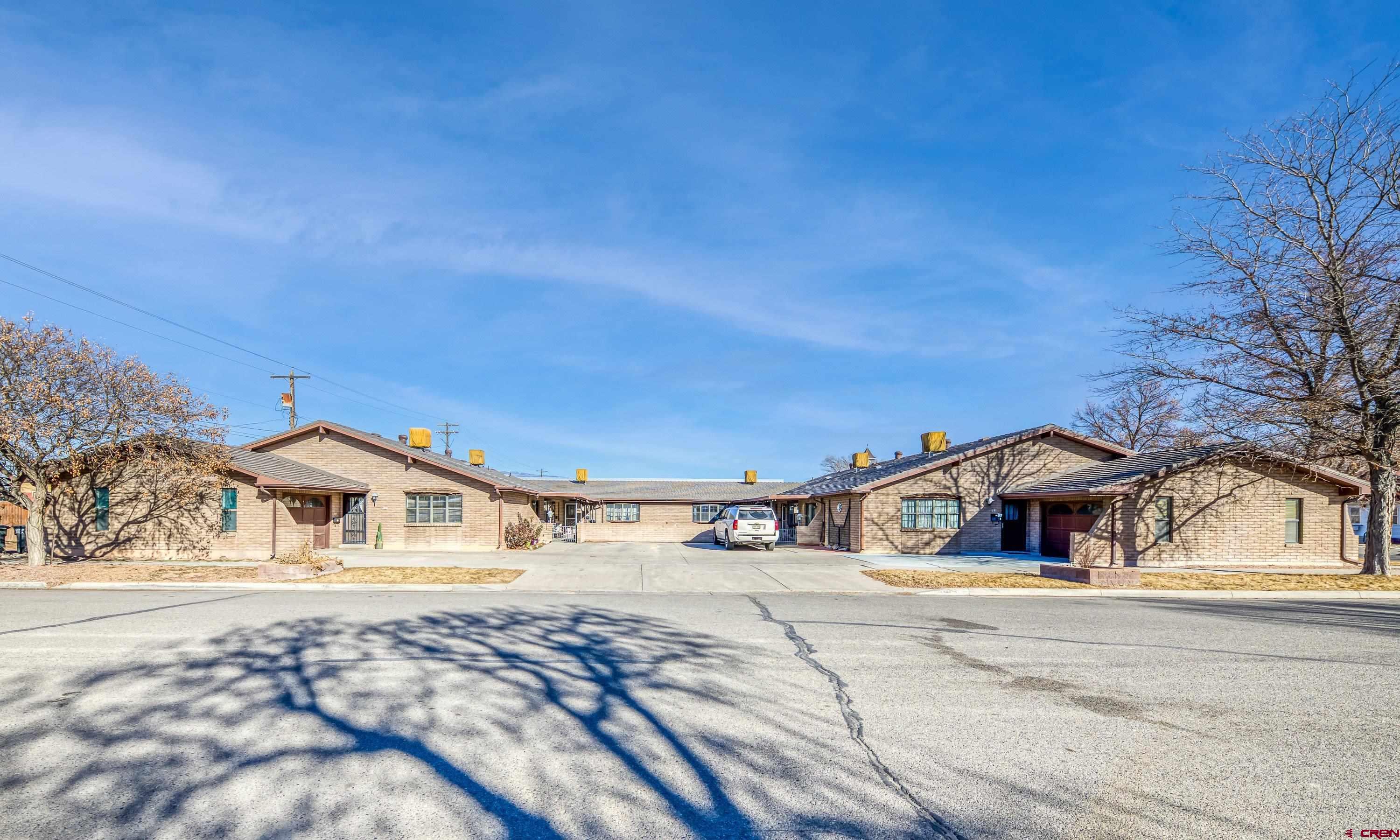 155 East 7th Street Delta, CO 81416 - Photo 17 of 19 a yellow house with trees in front of it
