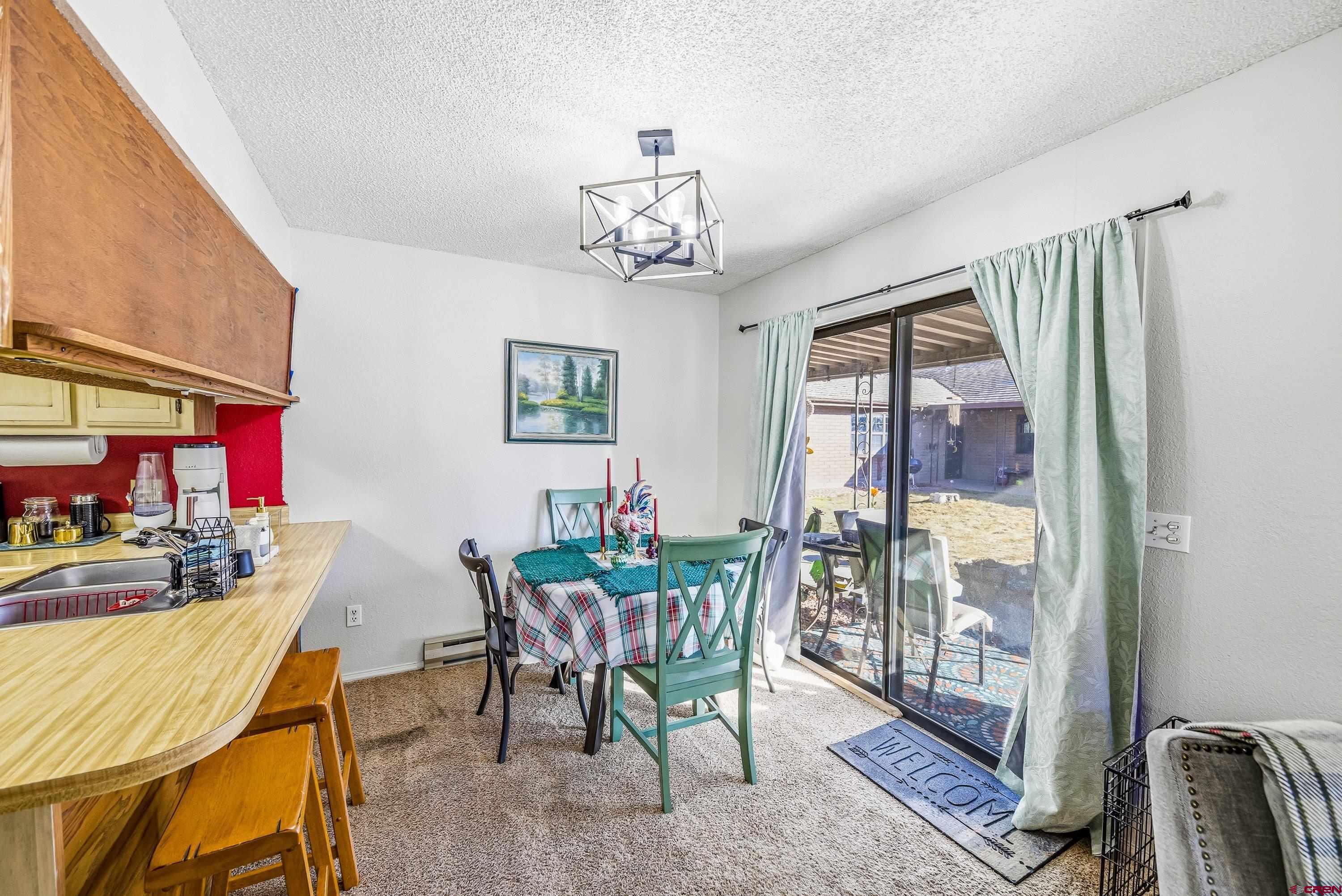 155 East 7th Street Delta, CO 81416 - Photo 6 of 19 a view of a dining room with furniture window and outside view