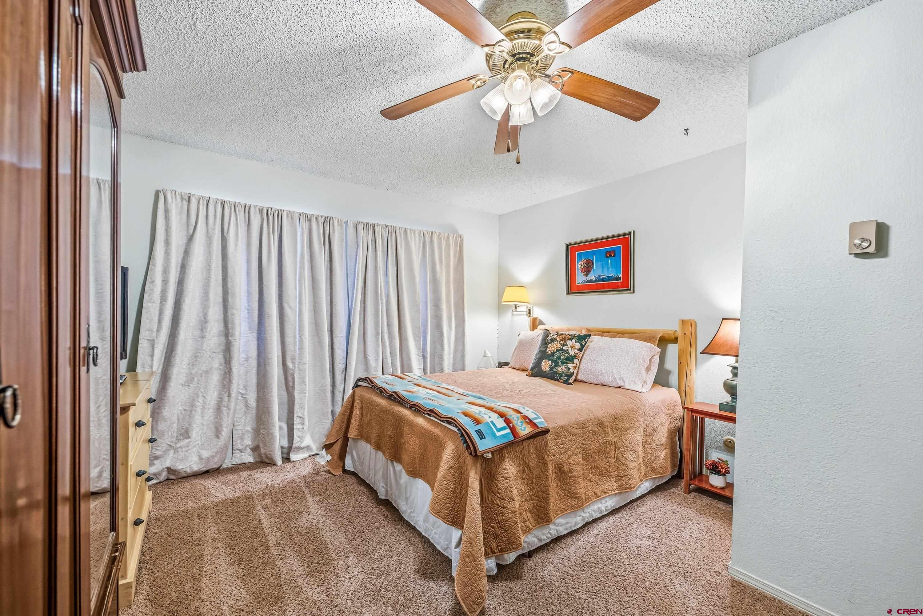 155 East 7th Street Delta, CO 81416 - Photo 10 of 19 a bedroom with a bed and a chandelier