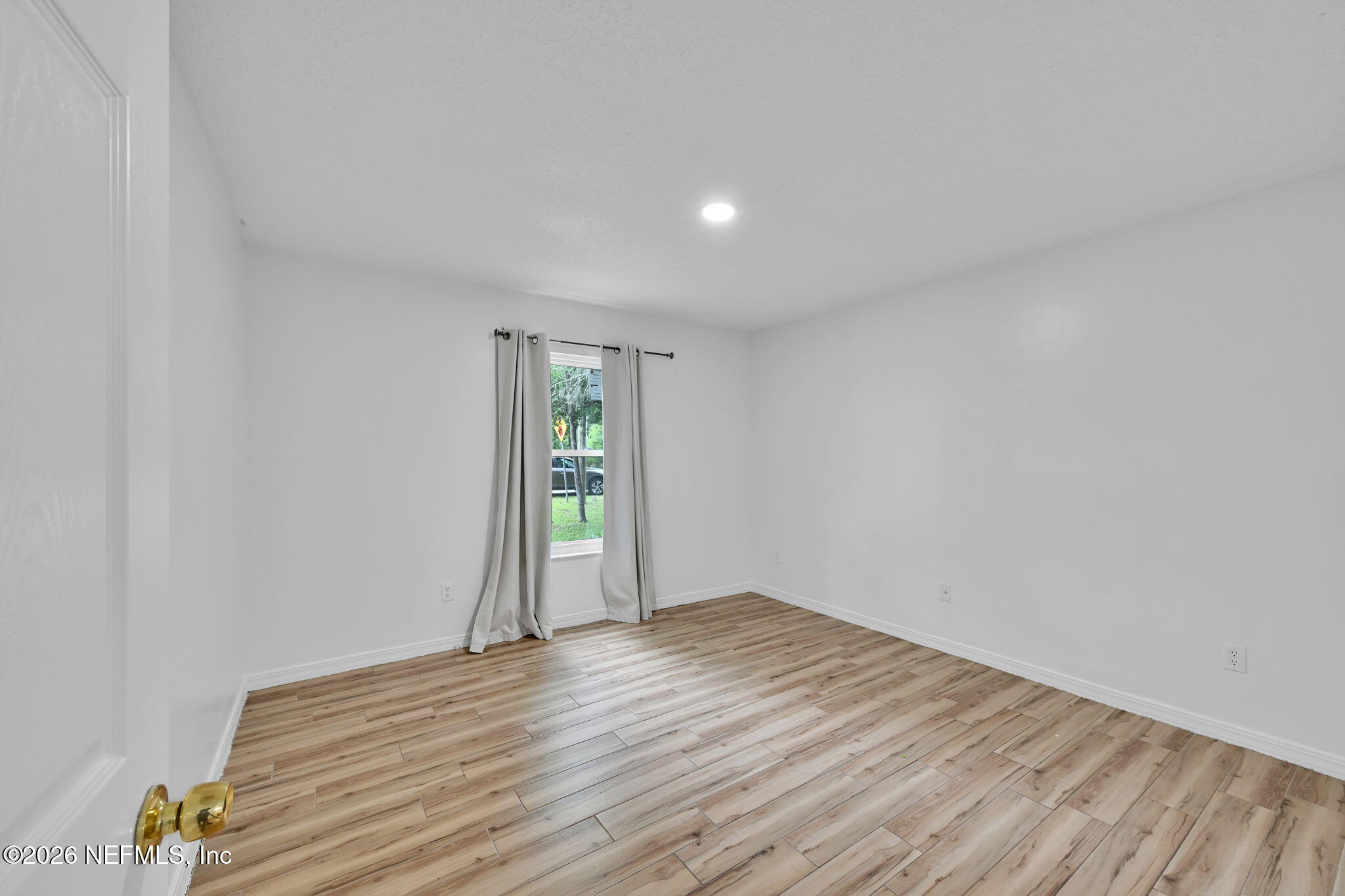 1110 Woodlawn Road, Unit D St. Augustine, FL 32084 - Photo 16 of 40 a view of empty room with wooden floor and fan