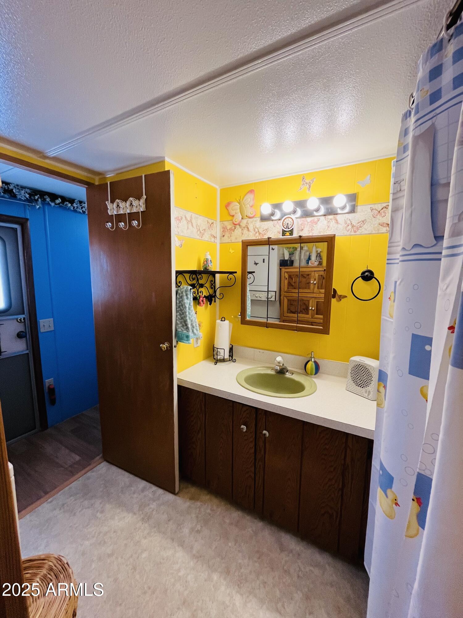 2100 North Trekell Road, Unit 17 Casa Grande, AZ 85122 - Photo 14 of 25 a bathroom with a sink and a mirror