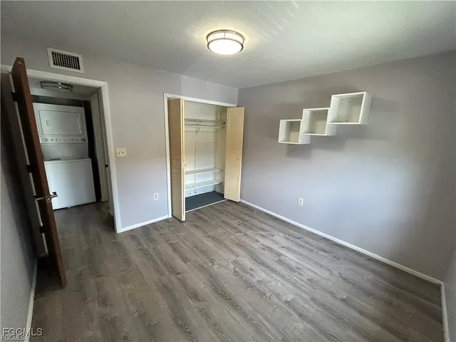 an empty room with wooden floor and a window