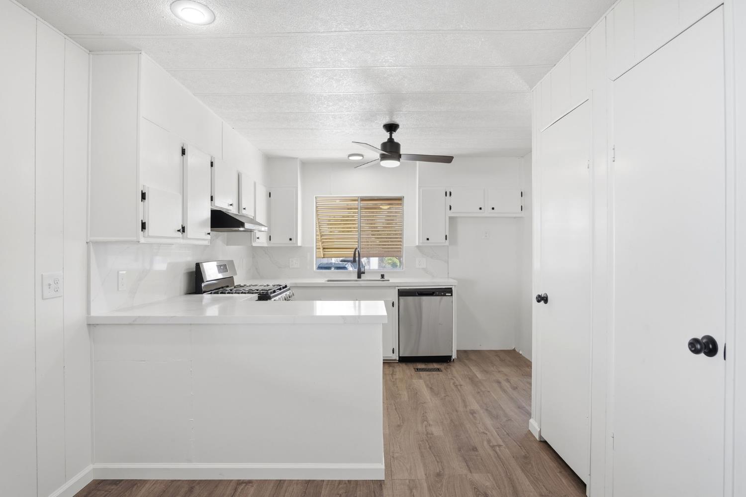 1200 South Carpenter Road, Unit 10 Modesto, CA 95351 - Photo 11 of 27 a kitchen with stainless steel appliances a sink stove and refrigerator