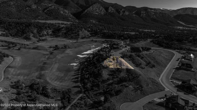 a view of a backyard with wooden fence