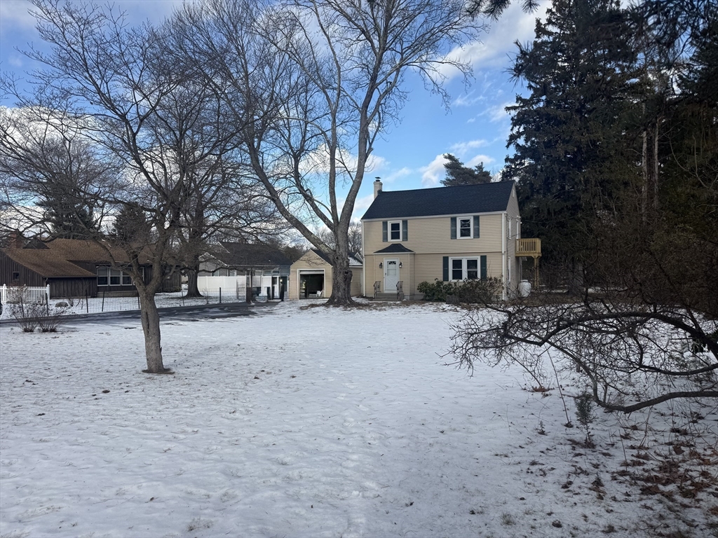 a view of house with a yard covered in snow