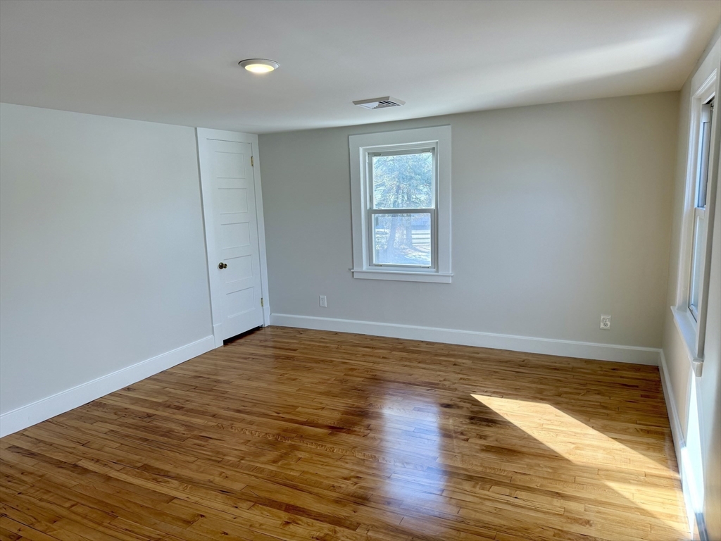 424 Chapin Street Ludlow, MA 01056 - Photo 18 of 32 a view of an empty room with wooden floor and a window