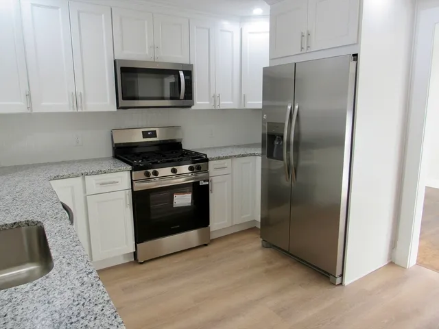 a kitchen with a stove microwave and refrigerator