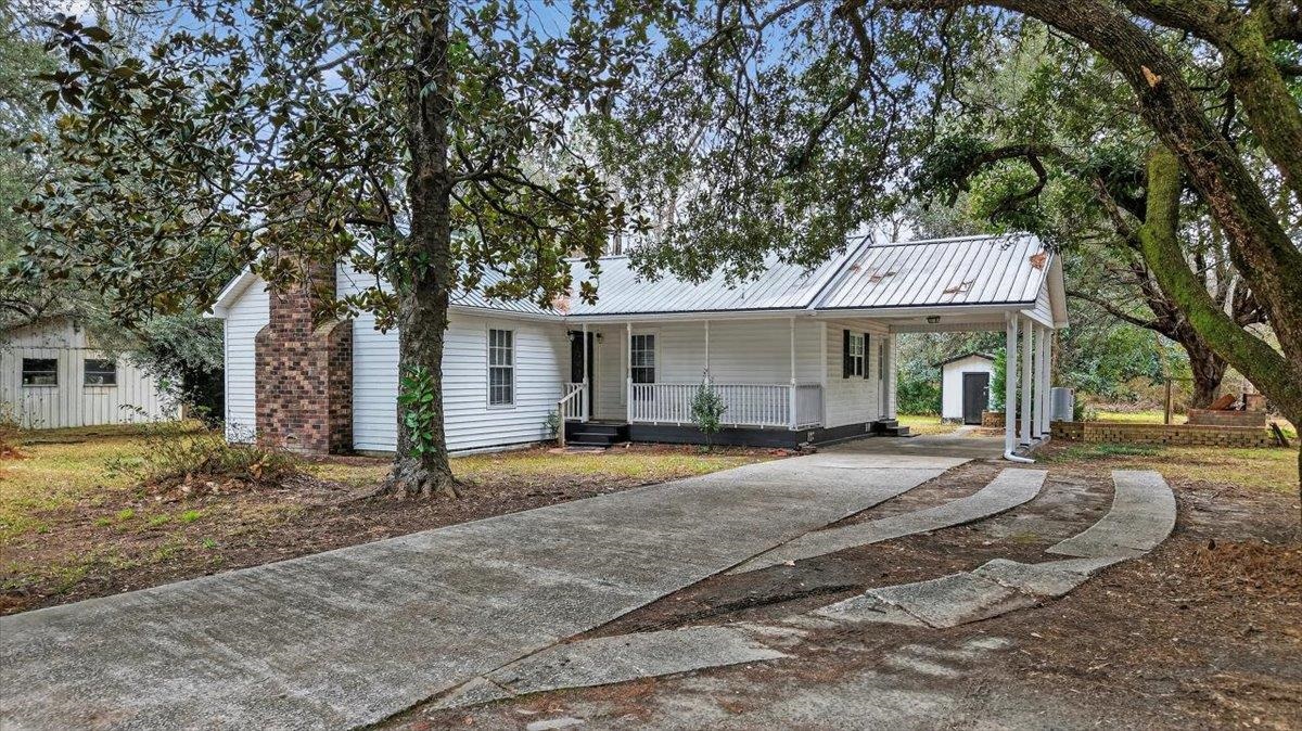 2137 North N Highway Bonneau, SC 29431 - Photo 1 of 19 View of front of house featuring a carport, driveway, a porch, and a metal roof