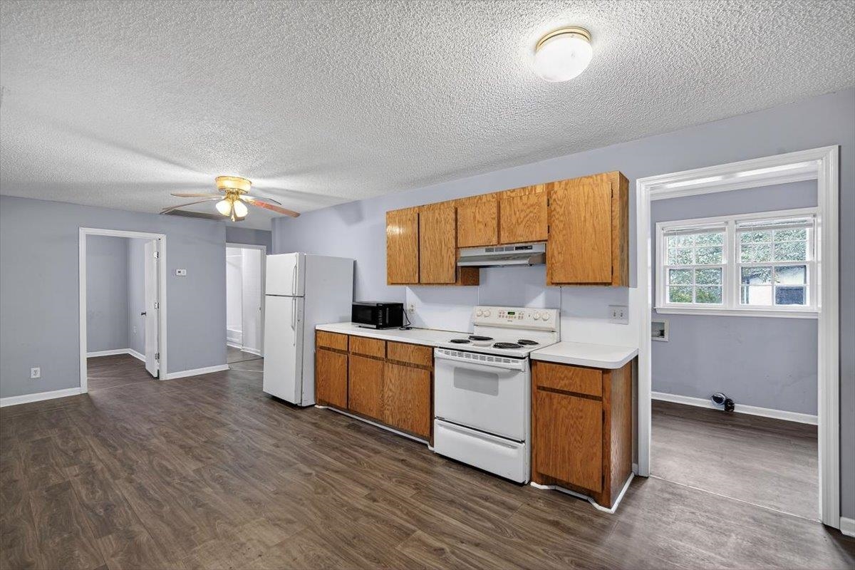2137 North N Highway Bonneau, SC 29431 - Photo 8 of 19 Oversized 23'x12' Kitchen with all appliances: Refrigerator, newer dishwasher, microwave and electric range.