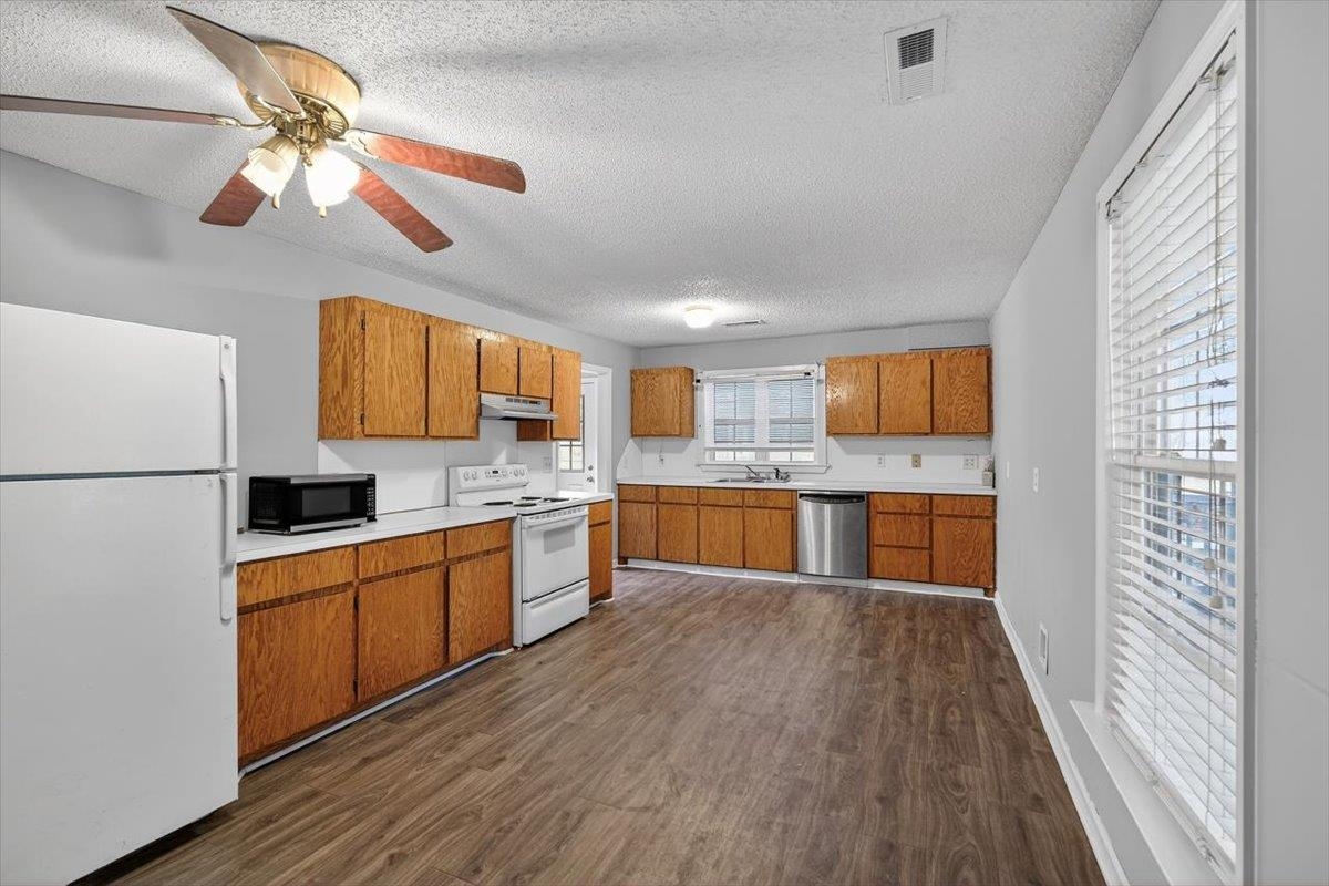 2137 North N Highway Bonneau, SC 29431 - Photo 9 of 19 Oversized kitchen with all appliances included. Newer dishwasher, electric range, microwave and refrigerator!