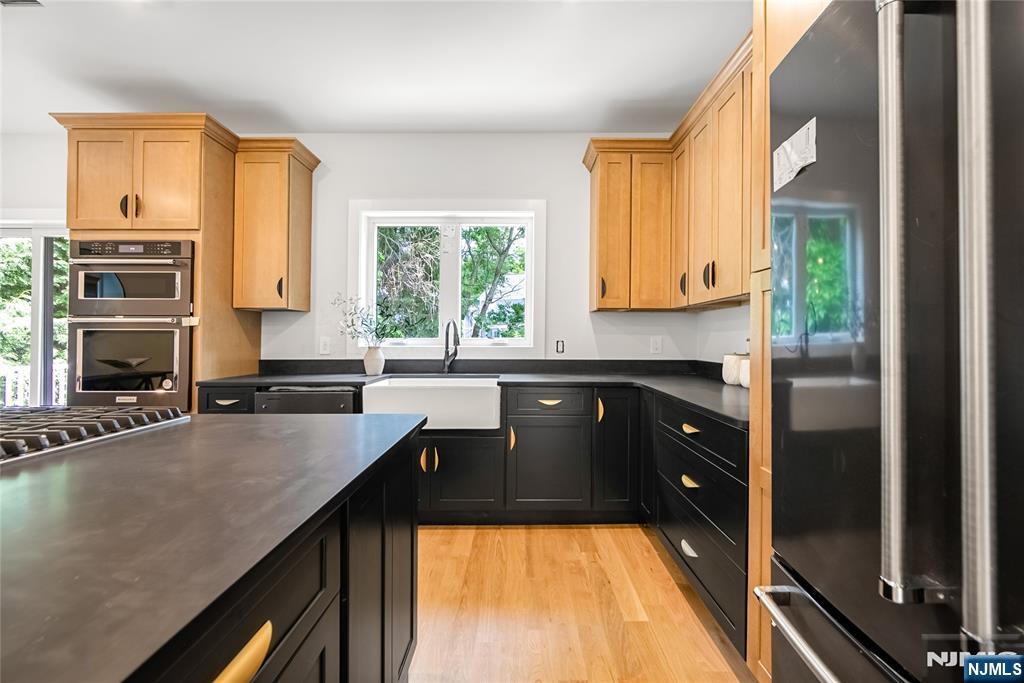429 Riverside Avenue Rutherford, NJ 07070 - Photo 14 of 32 a kitchen with a refrigerator a sink and a stove