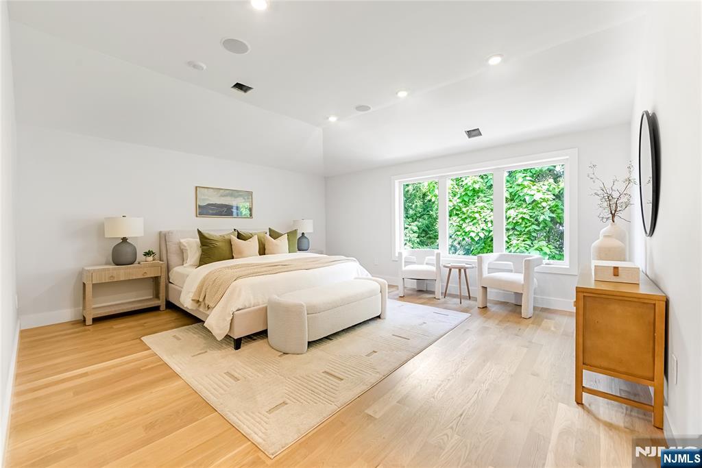 429 Riverside Avenue Rutherford, NJ 07070 - Photo 16 of 32 a spacious bedroom with a bed and a large window