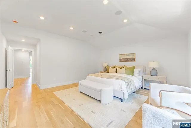 a spacious bedroom with a bed and a couch