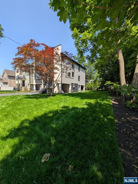 429 Riverside Avenue Rutherford, NJ 07070 - Photo 2 of 32 a view of a house with a big yard and large trees