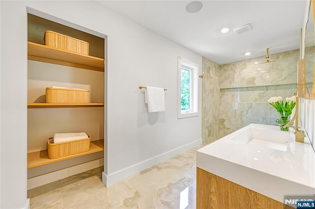 429 Riverside Avenue Rutherford, NJ 07070 - Photo 24 of 32 a bathroom with a granite countertop sink a mirror and a shower