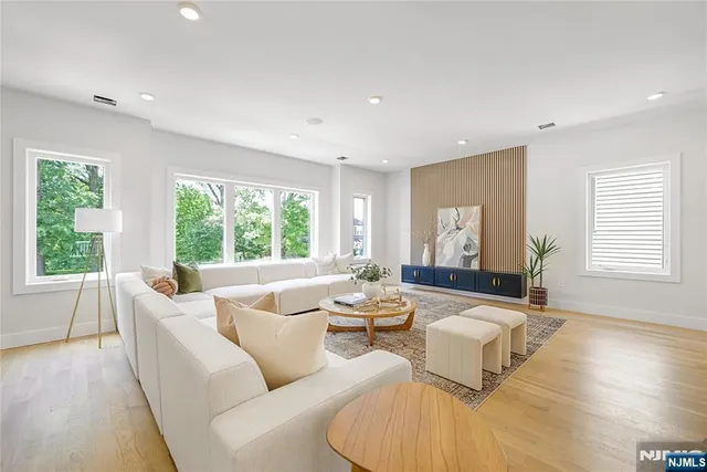 a living room with furniture and large windows