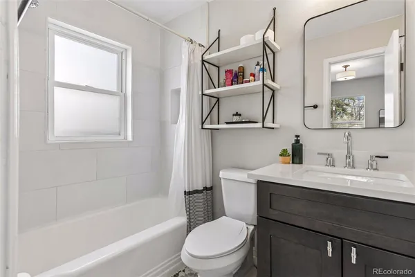a bathroom with a sink a toilet and a bathtub