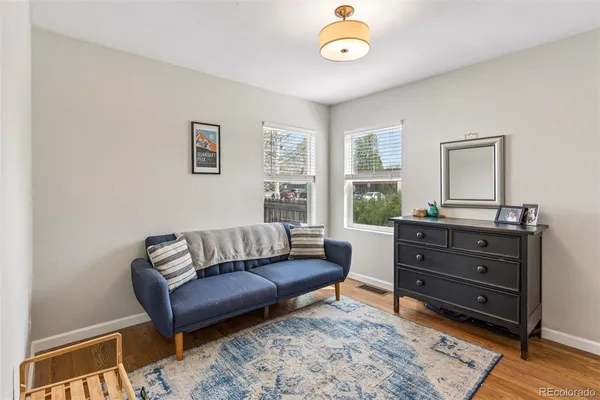 a living room with a couch and a dresser
