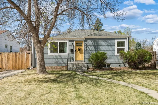 a view of a house with backyard and tree